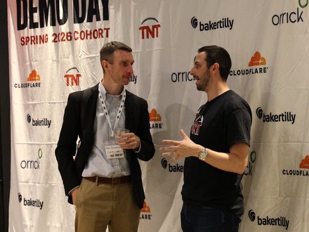 Conversation at the Demo Day backdrop